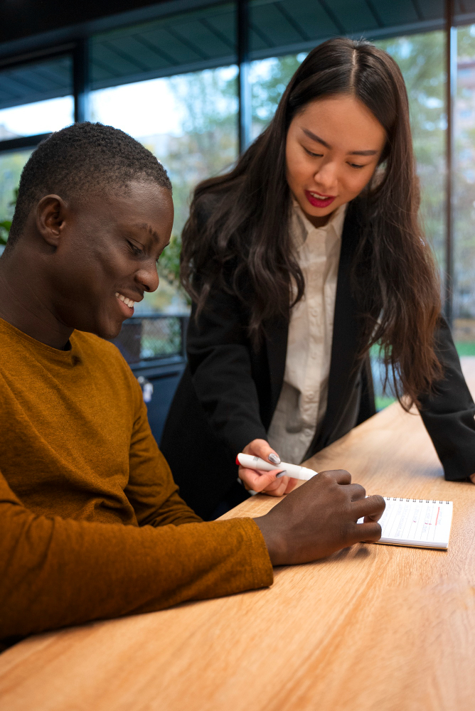 Student and consultant meeting in a warm daylight office setting